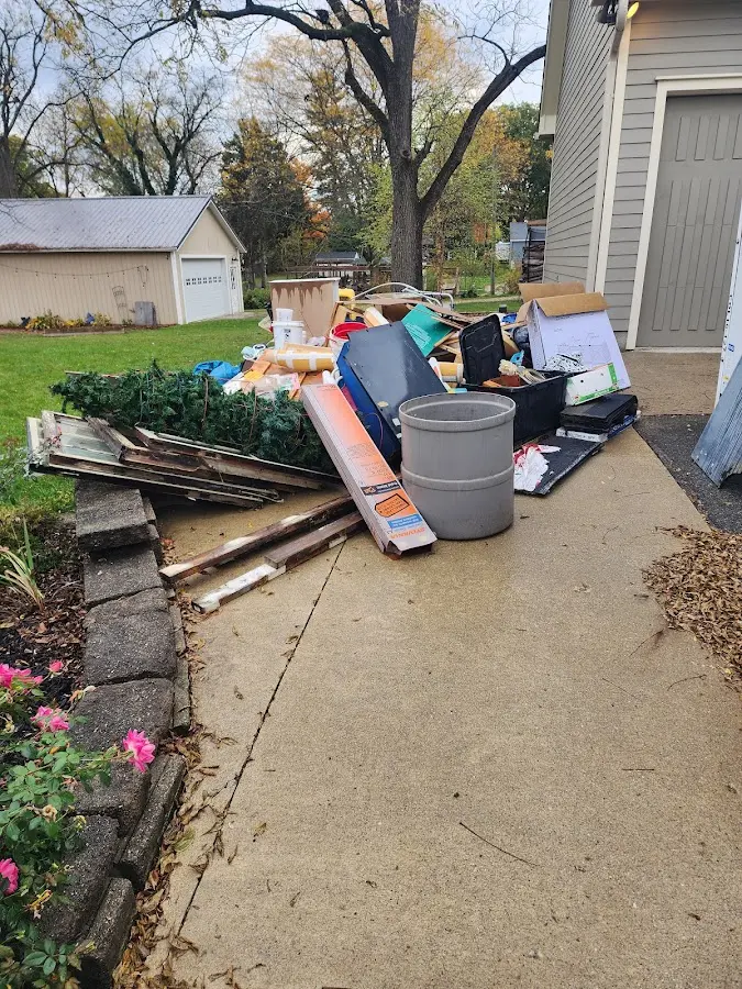 Dumpster being loaded with debris for 12 Yard Dumpster Rental in Shelburne